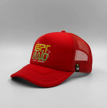Load image into Gallery viewer, A red / orange trucker cap with a graphic text 'PORTLAND' on the front.