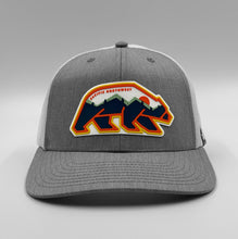 Load image into Gallery viewer, Gray and white Pacific Northwest cap with colorful bear design on a gray background
