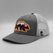 Load image into Gallery viewer, Gray and white Pacific Northwest cap with colorful bear design on a gray background
