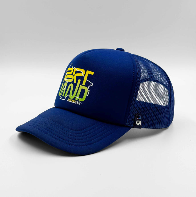A royal blue trucker cap with a graphic text 'PORTLAND' on the front.